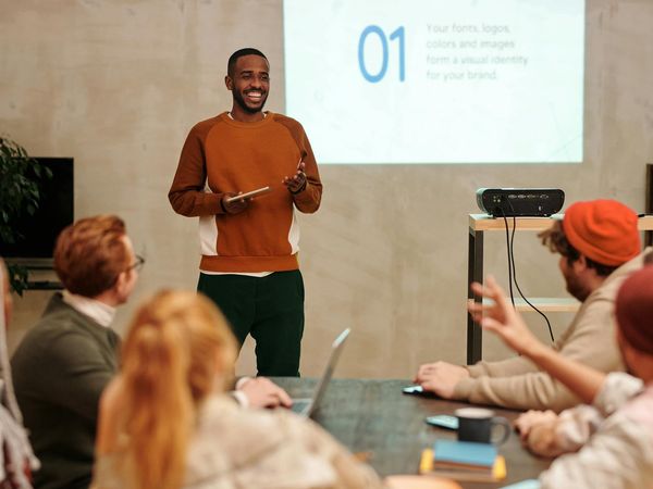 Diverse group of people smiling in a bright, modern room.